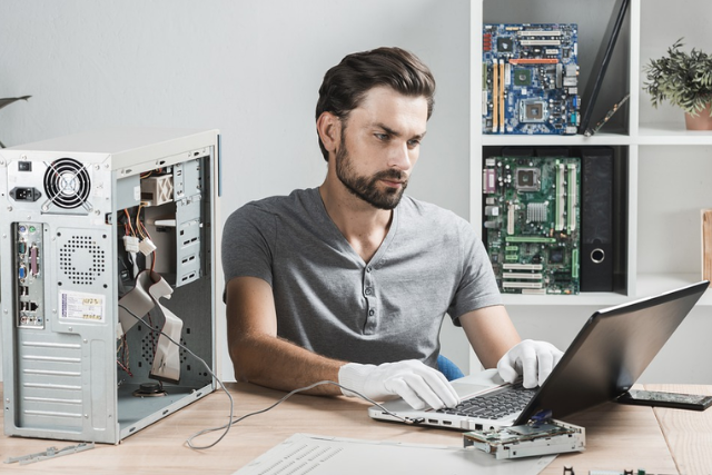 man repairing computer